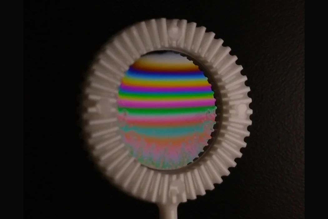 Soap bubble with rainbow-colored bands