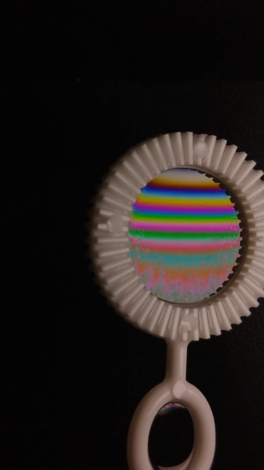 Soap bubble with rainbow-colored bands