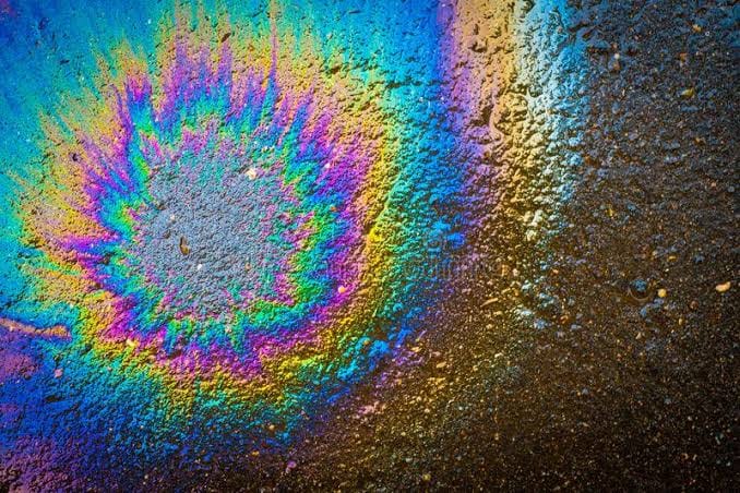 Rainbow-colored oil film on asphalt